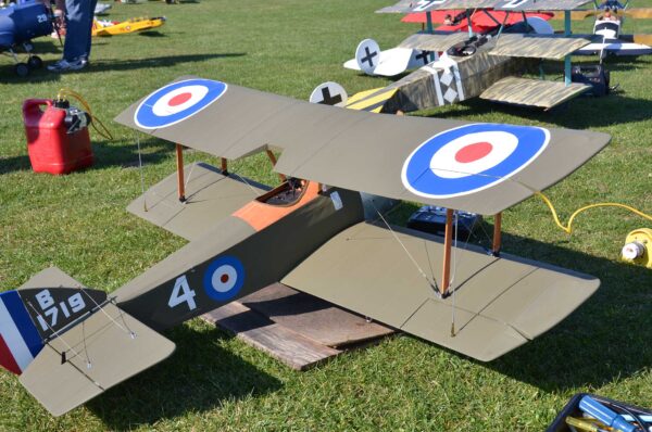 A small model of an airplane on the grass.